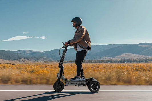 Rider on OOTD T30 scooter in a scenic valley