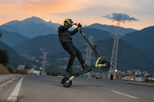 OOTD S30 off-road electric scooter being ridden by helmeted rider on mountain road at sunset